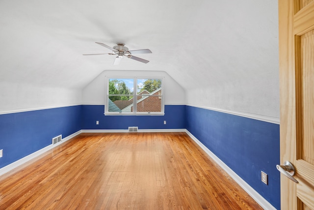 bonus room featuring vaulted ceiling, visible vents, wood finished floors, and ceiling fan