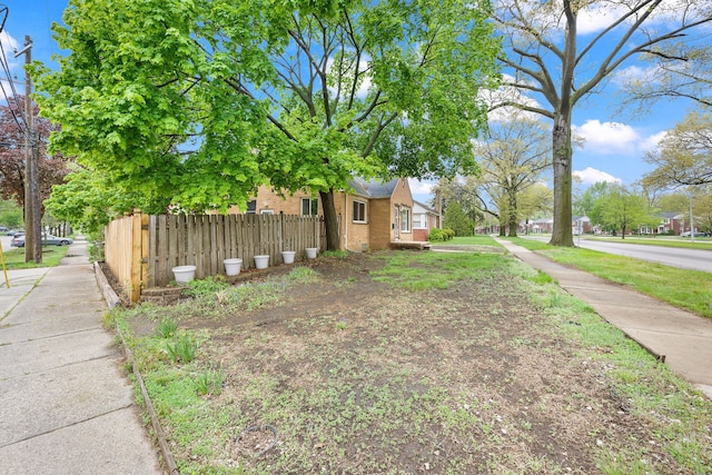 view of side of home featuring fence