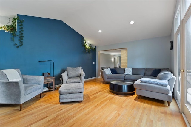 living area with vaulted ceiling, wood finished floors, and recessed lighting