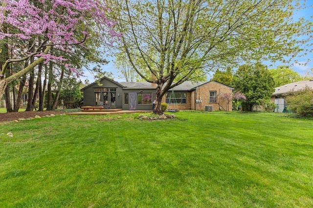 view of yard featuring cooling unit and a wooden deck