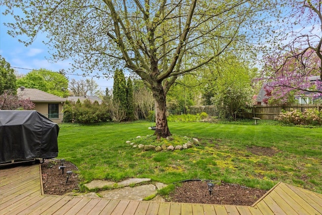 view of yard with fence and a wooden deck