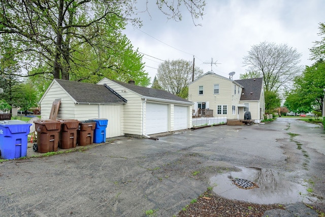 2847 N Custer Rd, Monroe, MI 48162 - view of home's exterior with an outbuilding, a garage, and roof with shingles