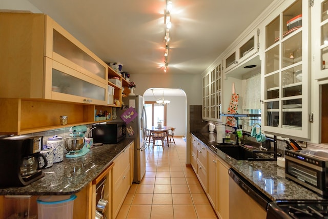 2847 N Custer Rd, Monroe, MI 48162 - kitchen featuring stainless steel appliances, arched walkways, rail lighting, light tile patterned floors, and a sink