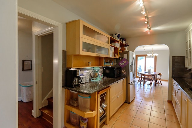 2847 N Custer Rd, Monroe, MI 48162 - kitchen with open shelves, arched walkways, black microwave, and track lighting