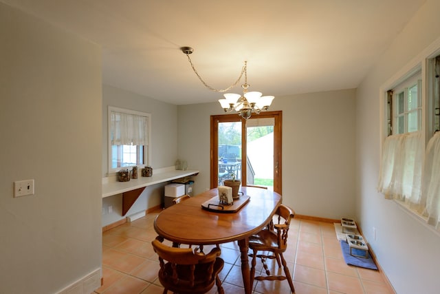 2847 N Custer Rd, Monroe, MI 48162 - dining area with a chandelier, light tile patterned flooring, and baseboards