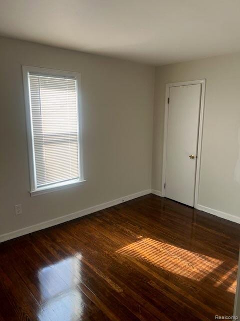 314 W 2nd Ave, Flint, MI 48503 - spare room featuring baseboards and wood finished floors