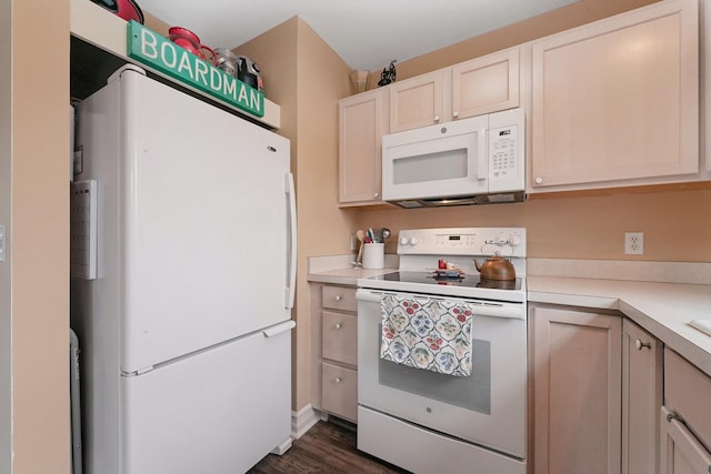 kitchen featuring white appliances, light countertops, and dark wood-style flooring