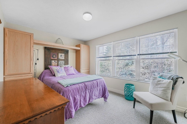 carpeted bedroom featuring baseboards