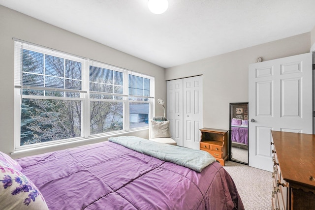 bedroom with light colored carpet and a closet