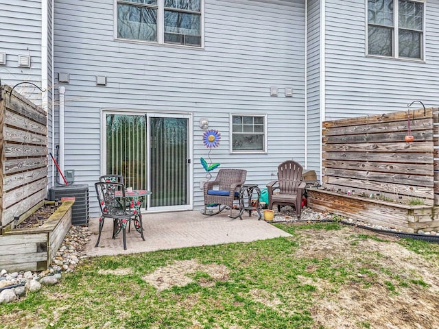 rear view of house featuring a patio area, a fenced backyard, and cooling unit