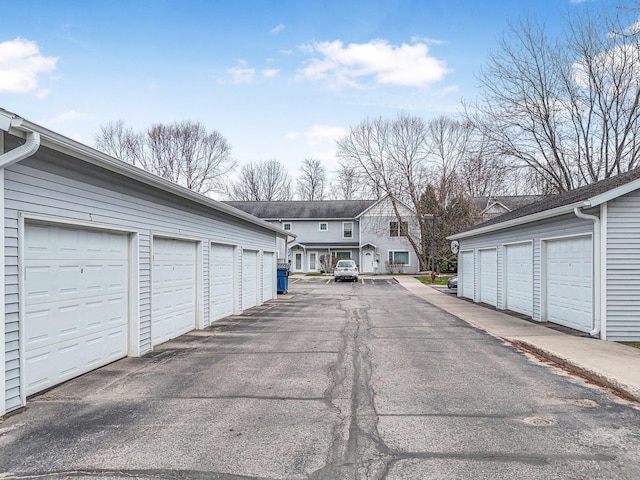 view of asphalt road with community garages and a residential view