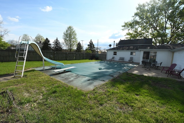 56193 Murray St, Mattawan, MI 49071 - view of swimming pool with a patio, a water slide, a lawn, and a fenced backyard