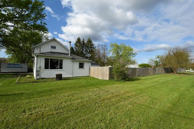 56193 Murray St, Mattawan, MI 49071 - back of house featuring a yard, fence, and central AC unit
