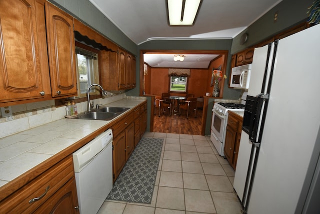 56193 Murray St, Mattawan, MI 49071 - kitchen featuring brown cabinets, white appliances, tile countertops, and a sink