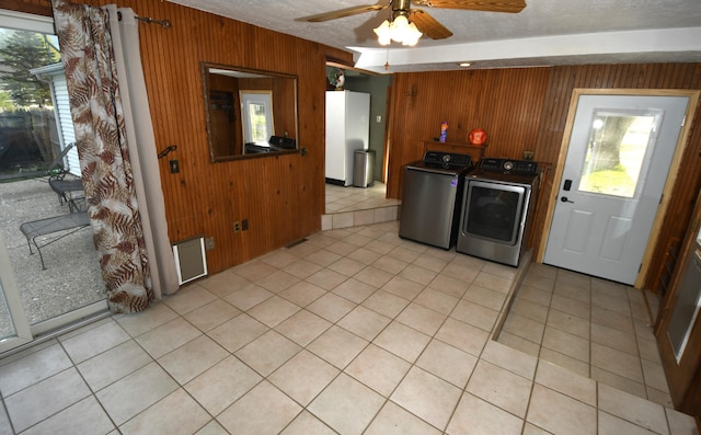 56193 Murray St, Mattawan, MI 49071 - laundry room with light tile patterned floors, separate washer and dryer, laundry area, ceiling fan, and wooden walls