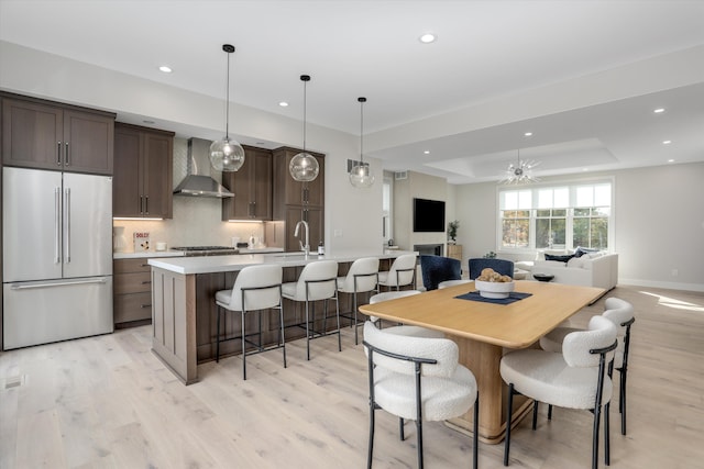 628 Maple St, Plymouth, MI 48170 - dining area with light wood finished floors, a tray ceiling, baseboards, and recessed lighting