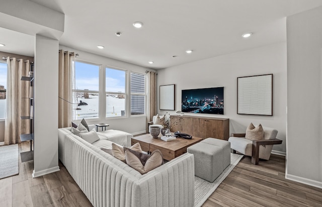 living area with wood finished floors, baseboards, and recessed lighting