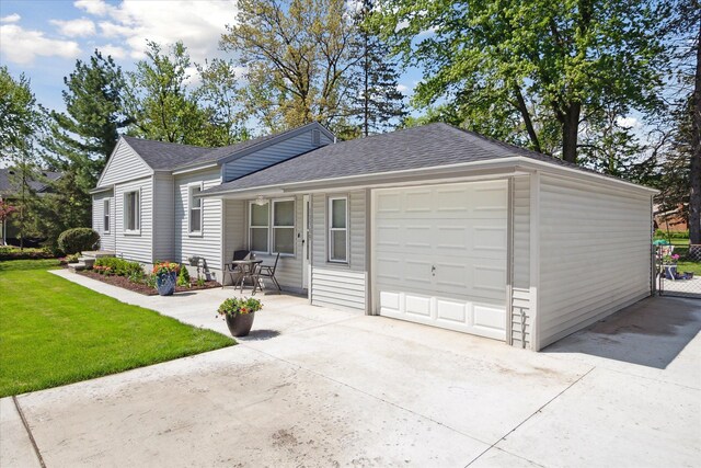 11389 Gold Arbor Rd, Plymouth, MI 48170 - view of front of house featuring concrete driveway, roof with shingles, a front lawn, and a garage
