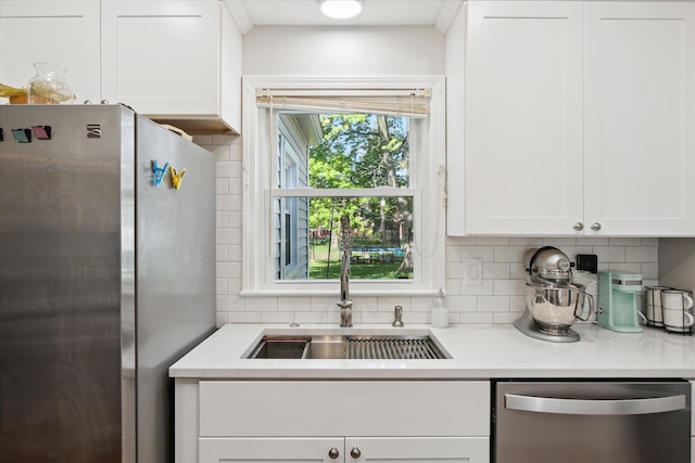 11389 Gold Arbor Rd, Plymouth, MI 48170 - kitchen featuring stainless steel appliances, a sink, backsplash, and white cabinetry