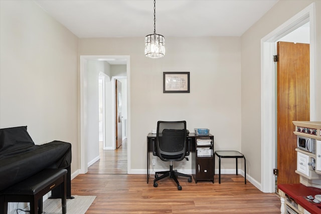 11389 Gold Arbor Rd, Plymouth, MI 48170 - home office with wood finished floors, baseboards, and a chandelier