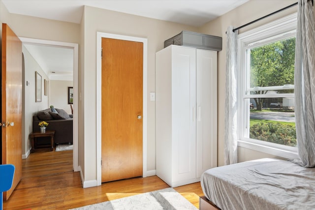 11389 Gold Arbor Rd, Plymouth, MI 48170 - bedroom with light wood-type flooring and baseboards