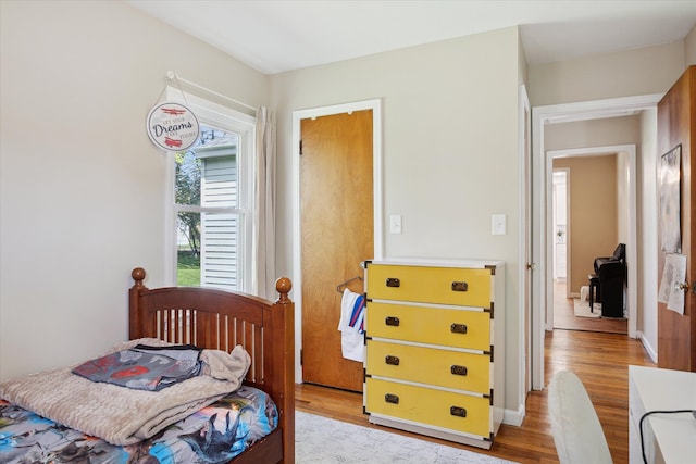 11389 Gold Arbor Rd, Plymouth, MI 48170 - bedroom featuring light wood-style floors and baseboards