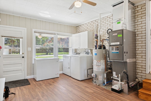 11389 Gold Arbor Rd, Plymouth, MI 48170 - washroom featuring water heater, washing machine and clothes dryer, cabinet space, light wood-type flooring, and ceiling fan