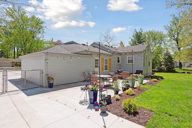 11389 Gold Arbor Rd, Plymouth, MI 48170 - back of property featuring a gate, a lawn, a patio, and roof with shingles