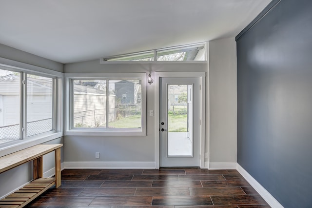 doorway to outside with wood tiled floors, baseboards, and lofted ceiling