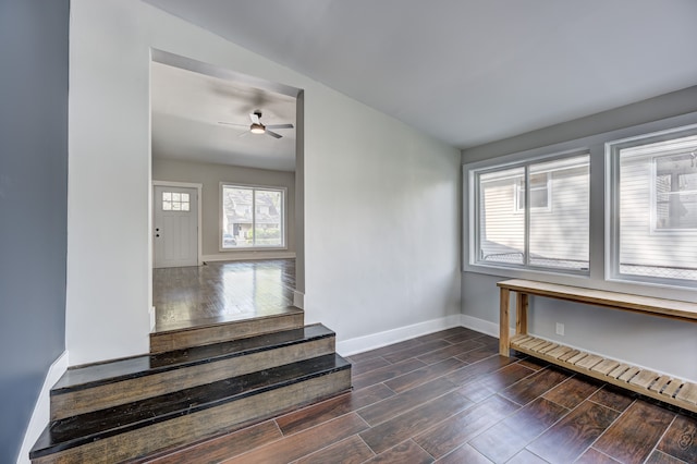 stairs with baseboards, wood finished floors, ceiling fan, and lofted ceiling