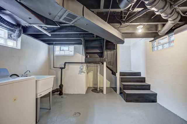 below grade area featuring washer / dryer, plenty of natural light, and stairway