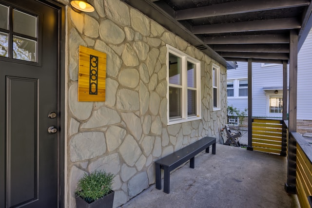 entrance to property featuring stone siding