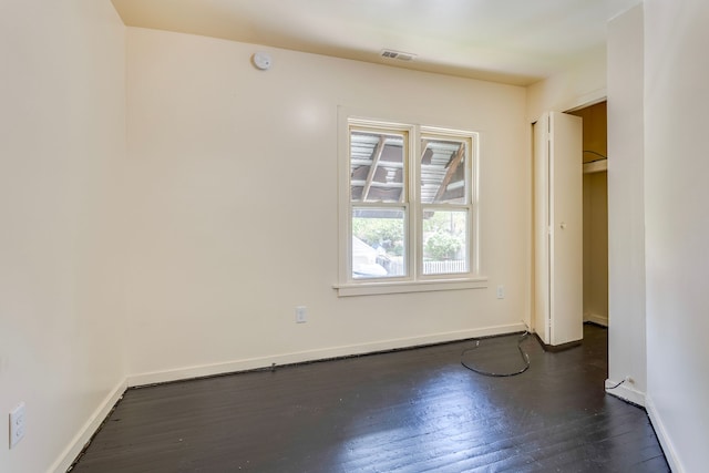 unfurnished bedroom featuring dark wood-type flooring and baseboards
