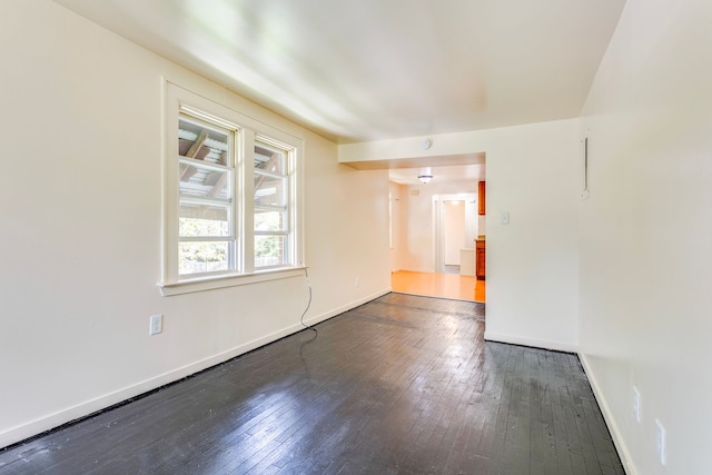 empty room featuring hardwood / wood-style floors and baseboards