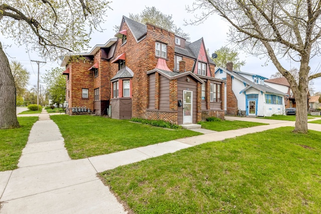 view of front of property with brick siding and a front lawn