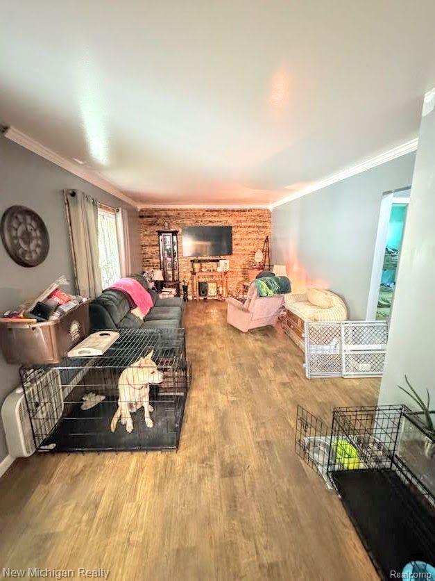212 Sunnybrooke Dr, Vernon, MI 48476 - living area with wood finished floors and ornamental molding