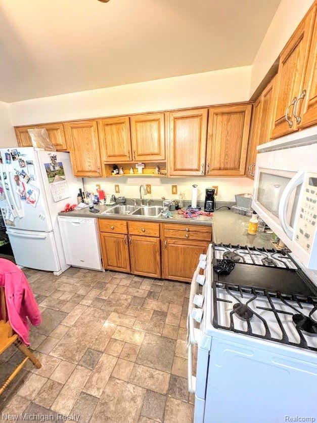 212 Sunnybrooke Dr, Vernon, MI 48476 - kitchen with white appliances, a sink, and stone finish floors
