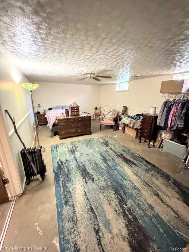 212 Sunnybrooke Dr, Vernon, MI 48476 - bedroom with concrete flooring and a textured ceiling