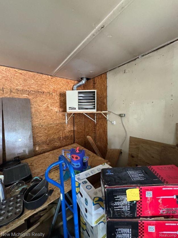212 Sunnybrooke Dr, Vernon, MI 48476 - storage room with a heating unit