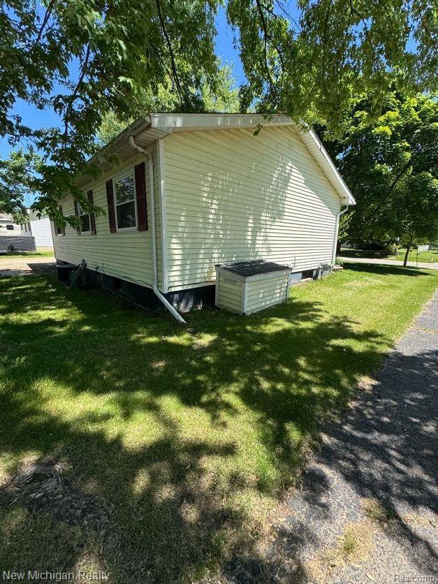 212 Sunnybrooke Dr, Vernon, MI 48476 - view of property exterior featuring a yard
