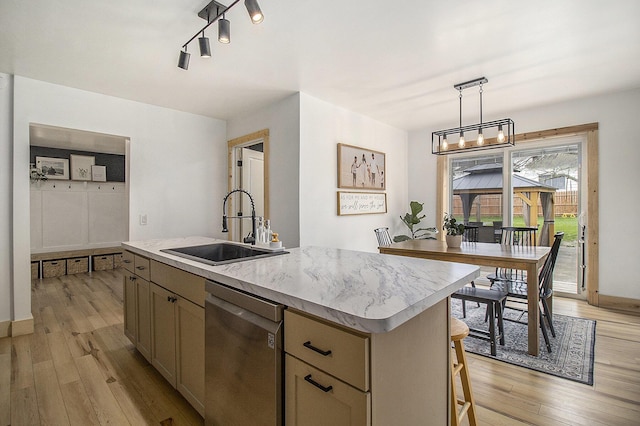 315 E Main St, Hart, MI 49420 - kitchen with an island with sink, light wood-type flooring, a sink, and dishwasher