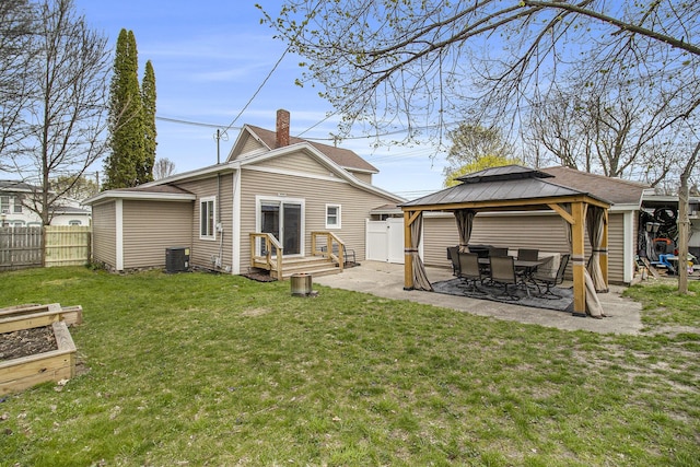 315 E Main St, Hart, MI 49420 - back of property featuring a patio, a chimney, fence, a lawn, and a gazebo