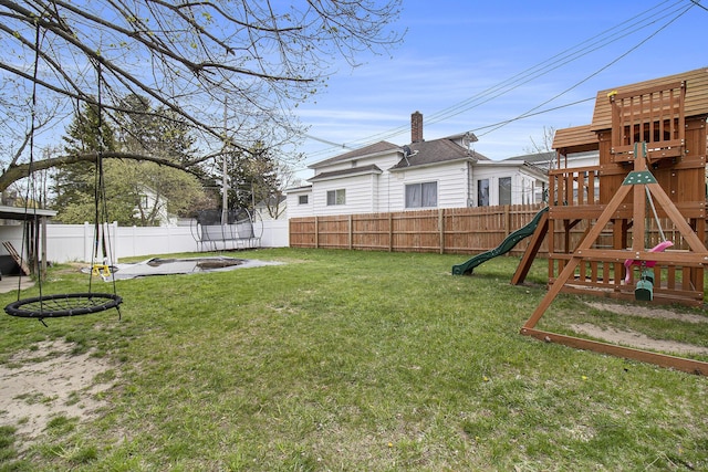 315 E Main St, Hart, MI 49420 - view of yard featuring a playground, a trampoline, and a fenced backyard