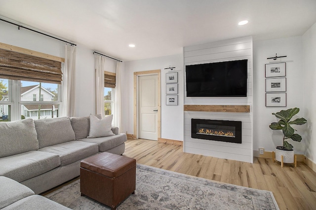315 E Main St, Hart, MI 49420 - living area featuring a fireplace, recessed lighting, baseboards, and wood finished floors