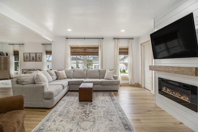 315 E Main St, Hart, MI 49420 - living area with recessed lighting, a glass covered fireplace, and light wood-type flooring
