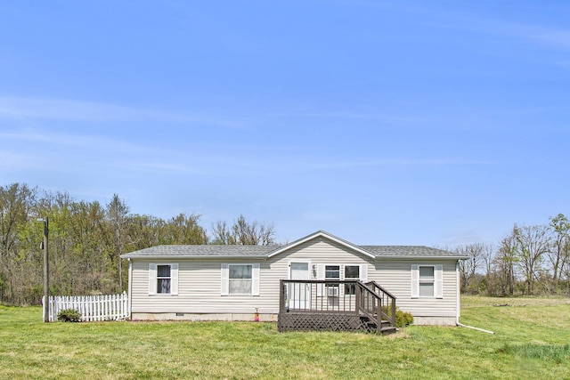 manufactured / mobile home with a deck, a front lawn, fence, and crawl space