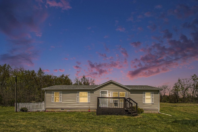 manufactured / mobile home with a front lawn, fence, and crawl space
