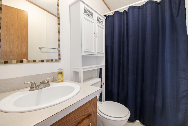 full bath with curtained shower, vanity, and toilet