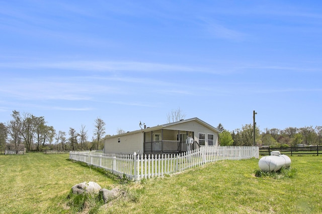 exterior space with a fenced front yard and a front lawn