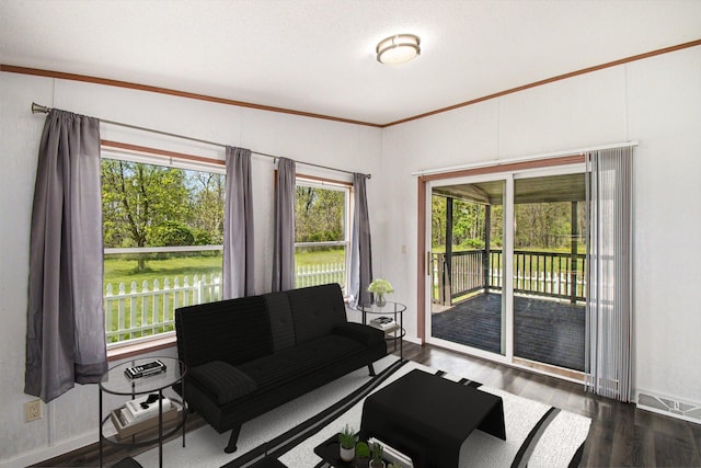 living room featuring crown molding, visible vents, baseboards, and dark wood-style floors